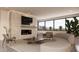 Cozy living room features a fireplace, large windows with desert views, and stylish furniture at 5761 N Echo Canyon Cir, Phoenix, AZ 85018