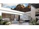 Outdoor patio with comfortable seating, a fire pit, and views of the home and surrounding landscape at 5761 N Echo Canyon Cir, Phoenix, AZ 85018