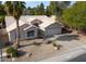 Single-story home with two-car garage and landscaped yard at 6413 W Irma Ln, Glendale, AZ 85308