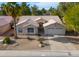 Single-story home with two-car garage and landscaped yard at 6413 W Irma Ln, Glendale, AZ 85308