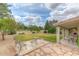 Spacious backyard with patio, grass, and mature trees at 6413 W Irma Ln, Glendale, AZ 85308