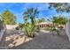 Spacious backyard with gravel and mature trees at 6413 W Irma Ln, Glendale, AZ 85308