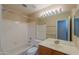 Clean bathroom with a tub, toilet and wood vanity at 6413 W Irma Ln, Glendale, AZ 85308