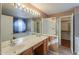 Bathroom with double sinks, soaking tub, shower, and walk-in closet at 6413 W Irma Ln, Glendale, AZ 85308