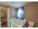 Bathroom with soaking tub and walk-in closet at 6413 W Irma Ln, Glendale, AZ 85308