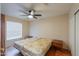 Bedroom with two beds, wood flooring, and ceiling fan at 6413 W Irma Ln, Glendale, AZ 85308