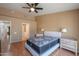 Main bedroom with queen bed, wood flooring and ensuite bathroom at 6413 W Irma Ln, Glendale, AZ 85308