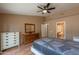 Bedroom with queen bed, dresser, and ceiling fan at 6413 W Irma Ln, Glendale, AZ 85308
