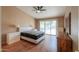 Main bedroom with a queen bed, wood flooring and ceiling fan at 6413 W Irma Ln, Glendale, AZ 85308