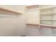 Large walk-in closet with shelves and hanging rods at 6413 W Irma Ln, Glendale, AZ 85308