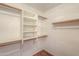 Spacious walk-in closet with shelves and hanging rods at 6413 W Irma Ln, Glendale, AZ 85308