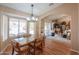 Bright dining area with wood floors and a glass-top table at 6413 W Irma Ln, Glendale, AZ 85308