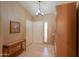 Entryway with tile floor, coat rack, and view of living room at 6413 W Irma Ln, Glendale, AZ 85308