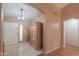 Bright entryway with tile flooring, wood cabinet, and access to other rooms at 6413 W Irma Ln, Glendale, AZ 85308