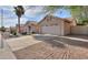Single story house with a two car garage and a fenced side yard at 6413 W Irma Ln, Glendale, AZ 85308