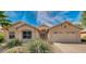 Tan two-story house with two-car garage and landscaping at 6413 W Irma Ln, Glendale, AZ 85308