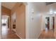 Long hallway with wood flooring, offering views into adjacent rooms at 6413 W Irma Ln, Glendale, AZ 85308