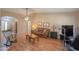Living room with hardwood floors, leather couch, and exercise equipment at 6413 W Irma Ln, Glendale, AZ 85308
