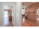 View into living room with wood flooring and access to other rooms at 6413 W Irma Ln, Glendale, AZ 85308