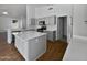 Modern kitchen with island, stainless steel appliances, and light gray cabinets at 6546 E Casa De Risco Ln, Gold Canyon, AZ 85118