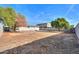 Large backyard with mature trees and partial fence at 8323 W Devonshire Ave, Phoenix, AZ 85037
