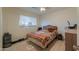 Bedroom with double bed, dresser, and wood floors at 8323 W Devonshire Ave, Phoenix, AZ 85037