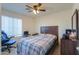 Cozy bedroom with double bed, ceiling fan, and window blinds at 8323 W Devonshire Ave, Phoenix, AZ 85037