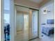 Bright hallway with mirrored closet and access to bathroom and bedroom at 8323 W Devonshire Ave, Phoenix, AZ 85037