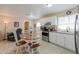 Modern kitchen with white cabinets, granite countertops, and stainless steel appliances at 8323 W Devonshire Ave, Phoenix, AZ 85037