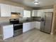 Bright kitchen features white cabinetry, stainless steel appliances, and granite countertops at 8323 W Devonshire Ave, Phoenix, AZ 85037