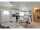 Modern kitchen with white cabinets, granite countertops, and a dining table at 8323 W Devonshire Ave, Phoenix, AZ 85037