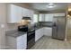 Bright kitchen features modern appliances, granite countertops, and white cabinets at 8323 W Devonshire Ave, Phoenix, AZ 85037