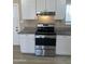 Stainless steel range is surrounded by modern white cabinets at 8323 W Devonshire Ave, Phoenix, AZ 85037