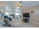 Open concept living room with a flat screen TV and comfortable seating at 8323 W Devonshire Ave, Phoenix, AZ 85037