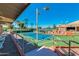 Tennis court with seating area and palm trees at 10008 E Michigan Ave, Sun Lakes, AZ 85248