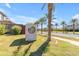 Modern community entrance with circular logo and landscaping at 10050 E Tiburon Ave, Mesa, AZ 85212