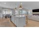 Open concept kitchen with island, white cabinets, and view into living room at 10050 E Tiburon Ave, Mesa, AZ 85212