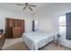 Spacious bedroom with a large bed, dresser and window at 10534 W Reade Ave, Glendale, AZ 85307