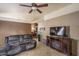 Living room with fireplace, TV, and comfy sofas at 10534 W Reade Ave, Glendale, AZ 85307