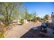 Spacious backyard, gravel and mature trees at 11034 W Alabama Ave, Sun City, AZ 85351