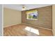 Bright bedroom featuring laminate flooring and neutral walls at 11034 W Alabama Ave, Sun City, AZ 85351