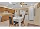 Bright dining area adjacent to kitchen, wood cabinets, and table with chairs at 11034 W Alabama Ave, Sun City, AZ 85351