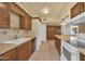 Galley style kitchen with wood cabinets and tile flooring at 11034 W Alabama Ave, Sun City, AZ 85351