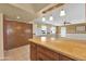 Kitchen boasts a breakfast bar and opens to the living room at 11034 W Alabama Ave, Sun City, AZ 85351