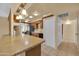 Kitchen features wood cabinets, tile countertops, and stainless steel appliances at 11034 W Alabama Ave, Sun City, AZ 85351