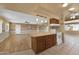 Open kitchen with island and wood cabinets at 11034 W Alabama Ave, Sun City, AZ 85351