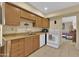 Bright kitchen features wood cabinets, and modern appliances at 11034 W Alabama Ave, Sun City, AZ 85351