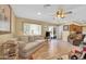 Living room with laminate floors, neutral walls, and patio access at 11034 W Alabama Ave, Sun City, AZ 85351