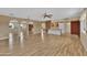 Bright living room with hardwood floors and views to the kitchen at 11034 W Alabama Ave, Sun City, AZ 85351