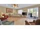 Comfortable living room with laminate flooring and access to patio at 11034 W Alabama Ave, Sun City, AZ 85351